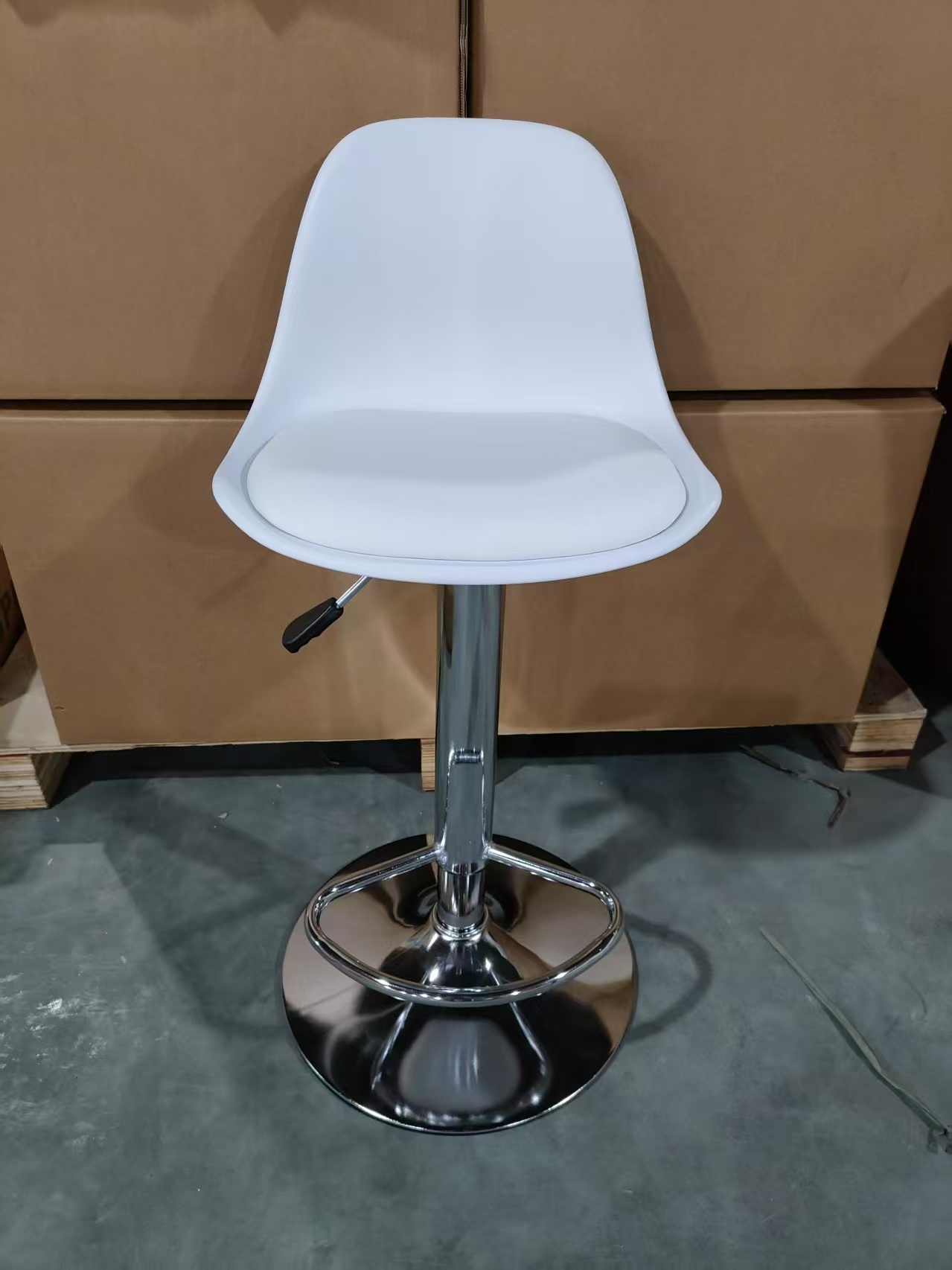 Front view of a white adjustable bar stool with a circular footrest and round chrome-look base